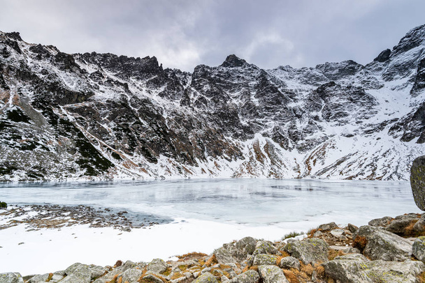 Black Pond or Czarny Staw and Rysy Peak in Tatra Mountains at Wi - Photo, Image