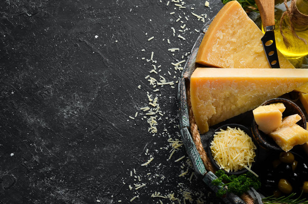 Piece of Parmesan cheese and cheese knife. On a stone background. Traditional Italian cheese. Top view. Free space for your text. - Zdjęcie, obraz