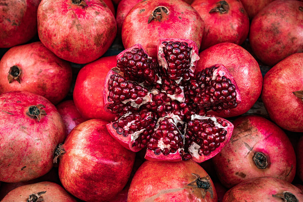 Red pomegranate fruit at street market. Group of pomegranates - Φωτογραφία, εικόνα