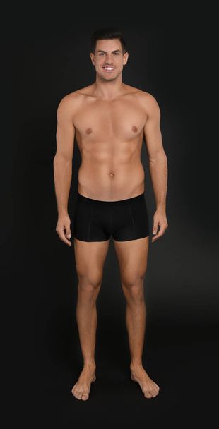 Handsome man in underwear on black background - Photo, image