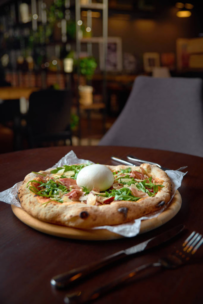 Food concept. Fresh original Italian Pizza with burrata, prosciutto and arugula. - Фото, зображення