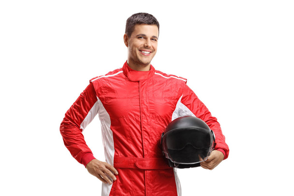 Male racer standing and holding a helmet  - 写真・画像
