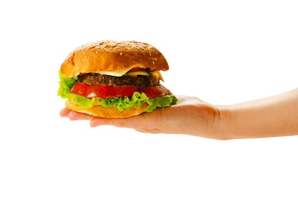 Hamburger lying on a round wooden board on a white background. - Foto, imagen