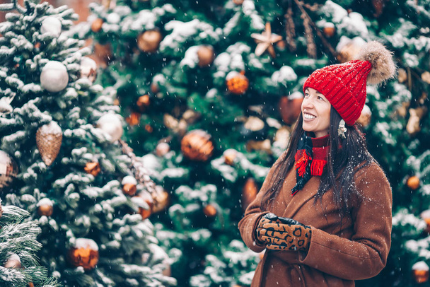 Happy girl near fir-tree branch in snow for new year. - Φωτογραφία, εικόνα