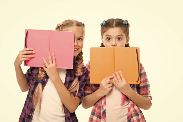 scared of exams. back to school. literature lesson. study homework. schoolgirls with notebook isolated on white. do homework together. learning language together. surprised pupils with work book - Foto, Bild