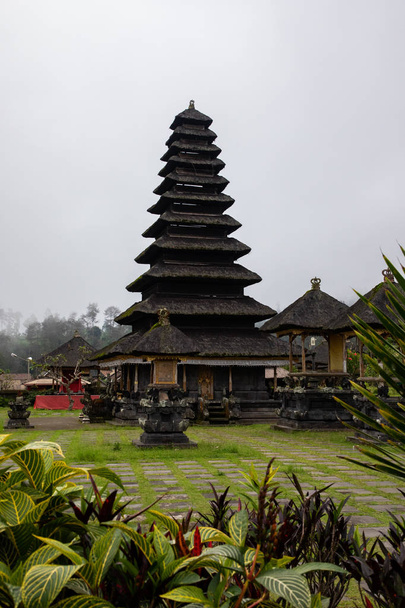Ancient balinese pagoda of a temple on a cloudy day - Photo, Image
