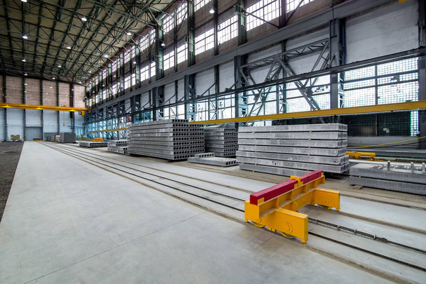 a plant for the production of hollow floor slabs with indoor equipment and new panels piled on a pile for the construction of buildings. - Photo, Image