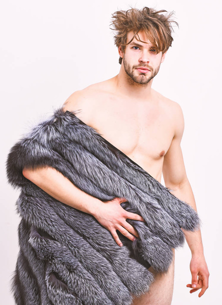 Sexy sleepy rich macho tousled hair fur vest on white background. Fashion and pathos. Guy attractive fashion model posing fur coat on naked body. Richness and luxury lifestyle. Fashion concept - Foto, Bild