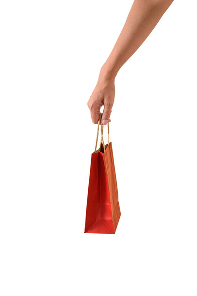 Female hand holding red papaer shopping bags - Foto, imagen