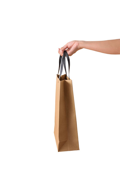 Female hand holding blank brown papaer shopping bags - Foto, imagen