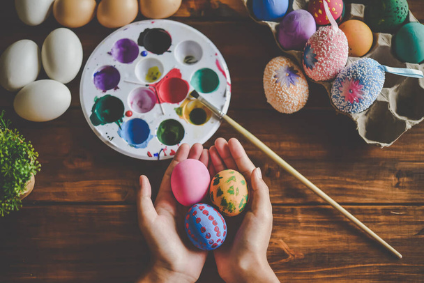 young girl painting Easter eggs for eastertime at home - Photo, Image