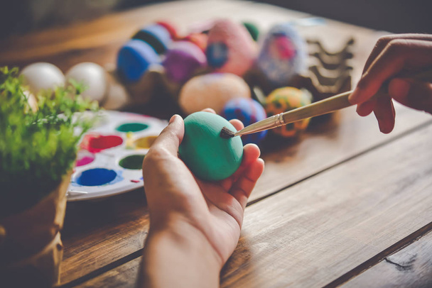 young girl painting Easter eggs for eastertime at home - Φωτογραφία, εικόνα