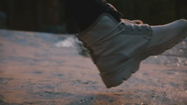 close up shot of male legs wearing grey desert shoes stepping right into small water stream on woods sunset slow motion - Filmagem, Vídeo