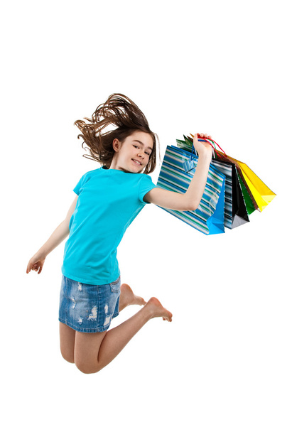 Young girl jumping with shopping bags - Foto, immagini