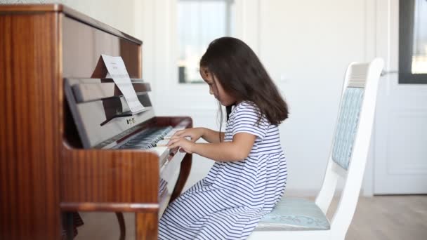 Kazakh asian little girl learning to play piano - Footage, Video