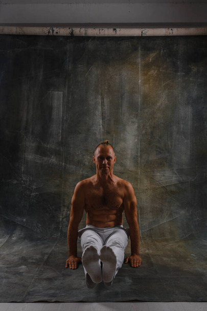 Handsome man doing yoga pose isolated on a white background - Foto, Imagem