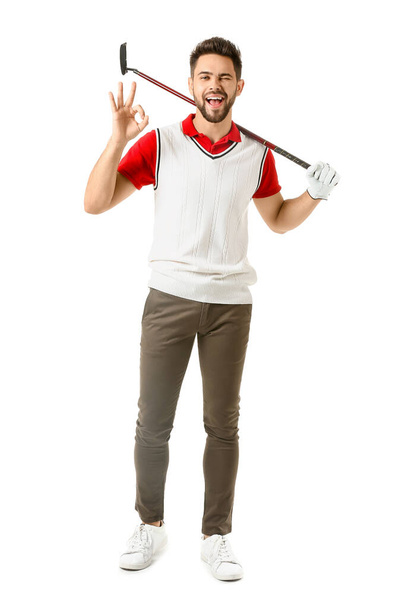 Красивый мужчина в гольф показывает ОК на белом фоне
 - Фото, изображение