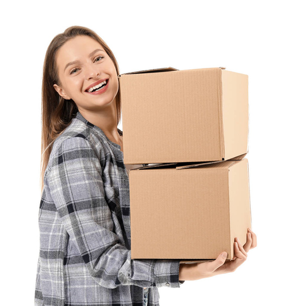 Young woman with moving boxes on white background - Фото, зображення