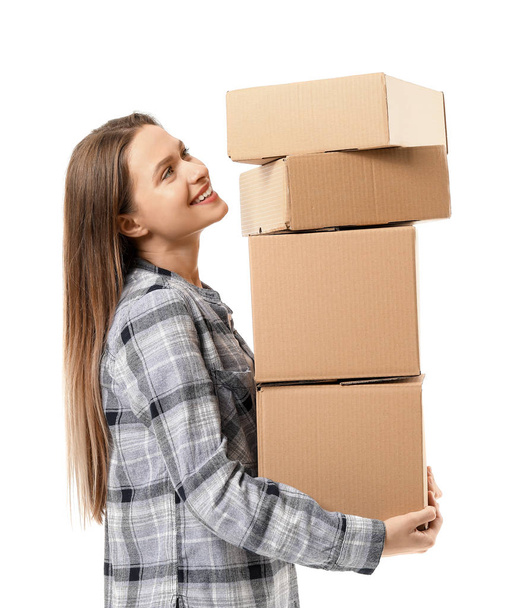 Young woman with moving boxes on white background - Fotoğraf, Görsel