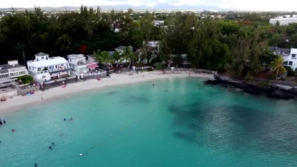 Aerial backwards flight of beautiful blue bay lagoon with white beach and luxus resorts - Кадри, відео