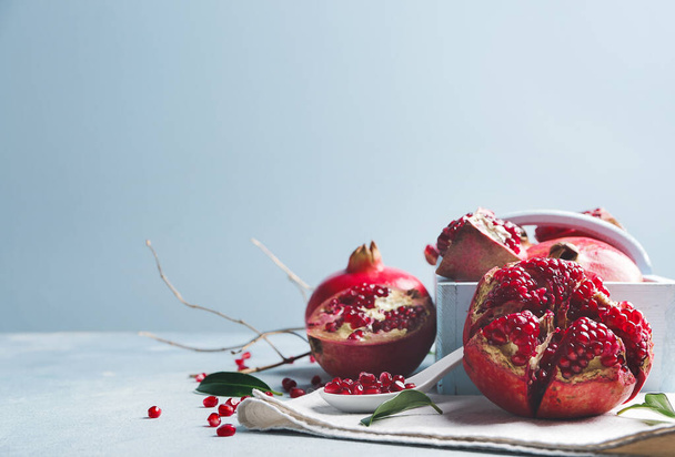Tasty pomegranate with leaves on white table - Photo, Image