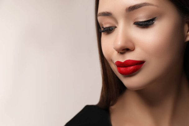 Beautiful woman with red lipstick on light background, space for text - Фото, изображение