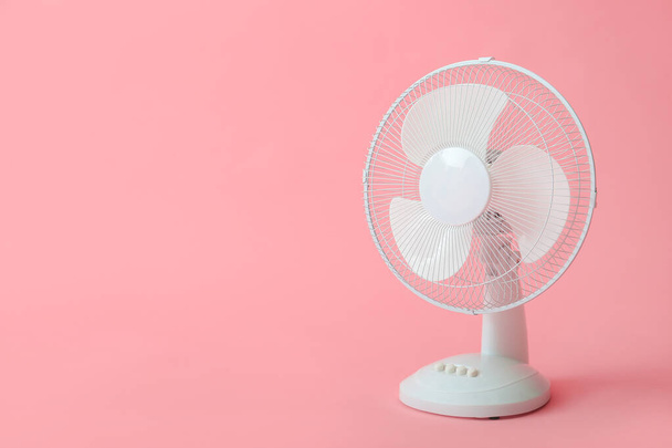Electric fan on color background - 写真・画像