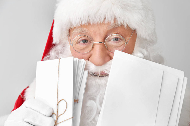 Santa Claus with letters on light background - Photo, Image