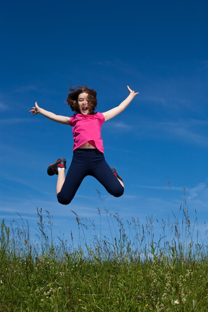 Girl running, jumping outdoors - Fotó, kép