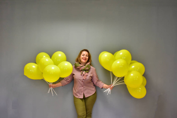 beautiful woman with yellow balls - Фото, изображение