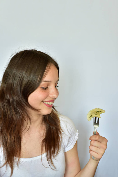 girl eats dumplings. Ukrainian national cuisine. Vfrtniki and pelmeni. - Photo, Image