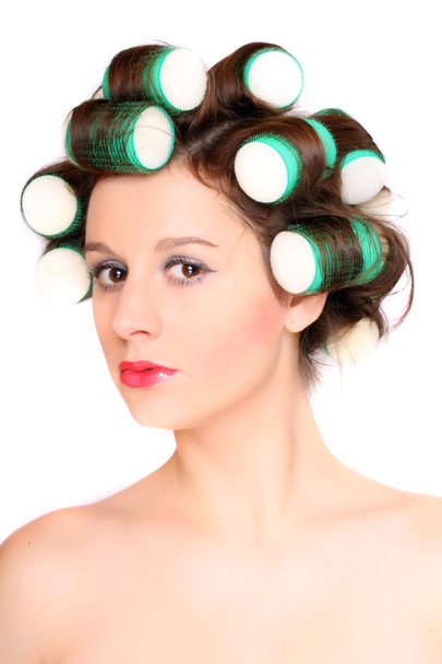 Girl is having hair curlers on her head - Photo, Image