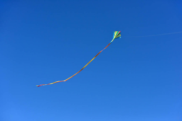 Kite flying in clear and blue sky on sunny daytime. - Φωτογραφία, εικόνα