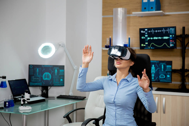 Patient woman exploring virtual reality in a modern laboratory - Photo, Image