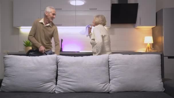 Joyful man and woman dancing , enjoying cleaning the house together, family - Felvétel, videó
