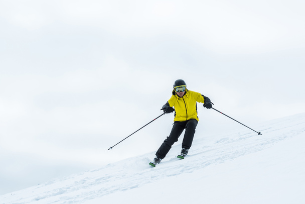 skier holding ski sticks and sporting in wintertime - Photo, Image