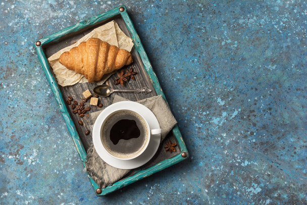 Appetizing crispy croissant and coffee for tasty breakfast - Photo, image