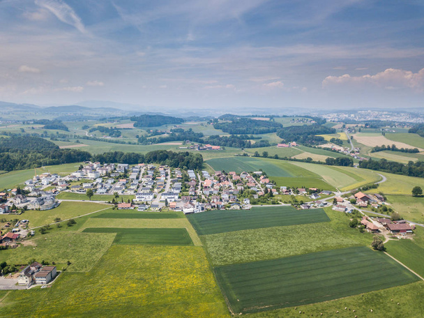 Aerial view of rural village in Switzerland with buildings - 写真・画像