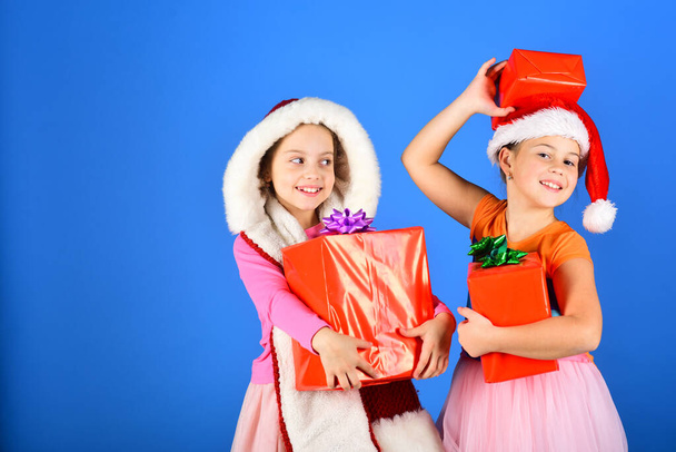 Girls have winter holidays, copy space. Sisters in Santa hats - Zdjęcie, obraz