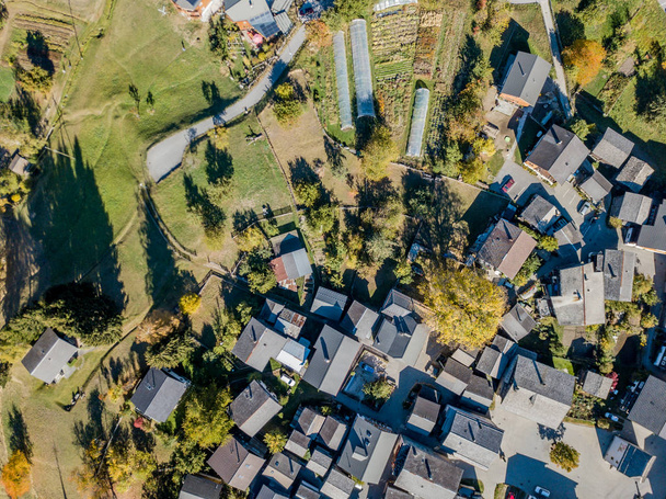 Aerial view of tiny houses in rural village in Swiss mountains - 写真・画像