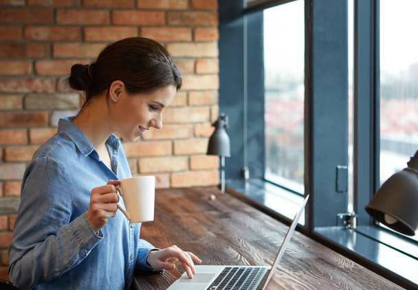 Woman working on laptop at open space office  - Φωτογραφία, εικόνα