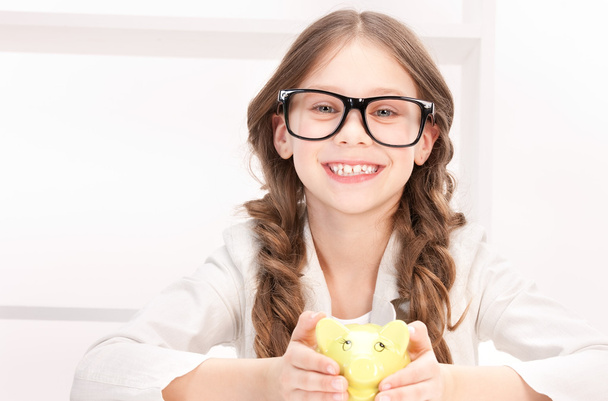 Little girl with piggy bank - Photo, image