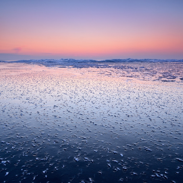 Colorful sunset at the snowy Baltic sea shore - Photo, Image