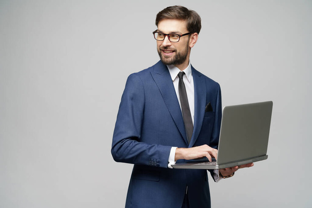 Young handsome businessman Holding a laptop Computer with Blank Screen - Photo, image