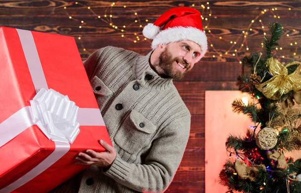 happy man with beard santa hat. present for you. only my. advantageous offer of winter discounts. christmas shopping sales. what a surprise. new year gift. man hols huge gift. Find presents online - Photo, image