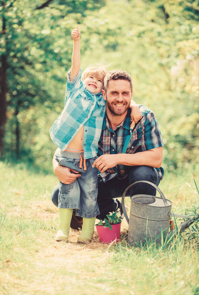 small boy child help father in farming. watering can, pot and hoe. Garden equipment. happy earth day. Family tree nursering. father and son in cowboy hat on ranch. Eco farm. Great plants - Foto, afbeelding