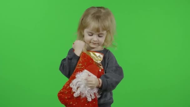 Happy beautiful little girl in a sweater with a snowman. Christmas. Chroma Key - Video, Çekim