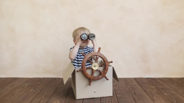 Happy child pretend to be sailor. Funny kid playing at home. Summer vacation and travel concept - Séquence, vidéo