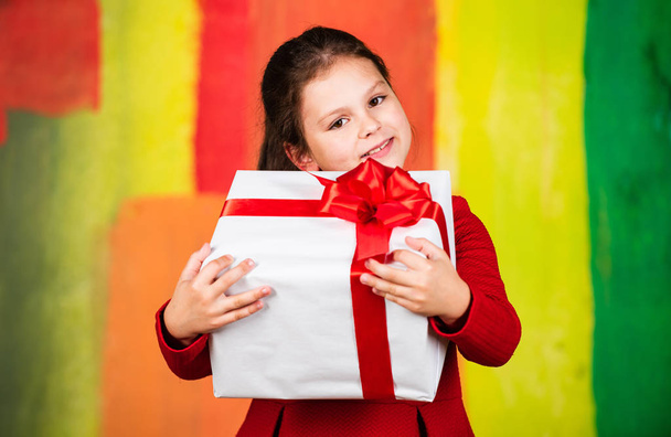 Happy holiday. big christmas sale. kid hold gift box. boxing day concept. dreams come true. happy new year. winter holiday and xmas joy. seasonal shopping discount. little girl carry present - Photo, Image