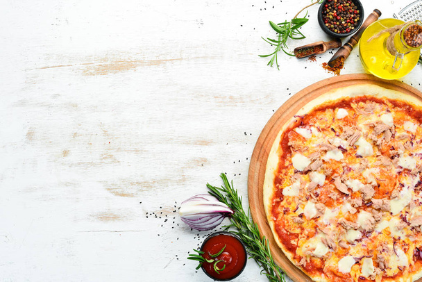 Traditional pizza with tuna and vegetables. Top view. free space for your text. Rustic style. - 写真・画像